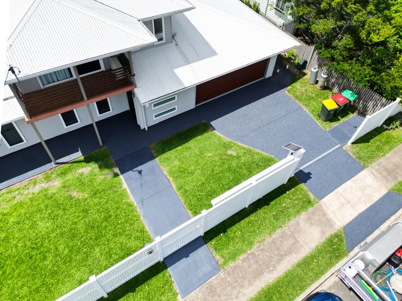 Aerial view of a new-build driveway and path sealed in a dark grey colour