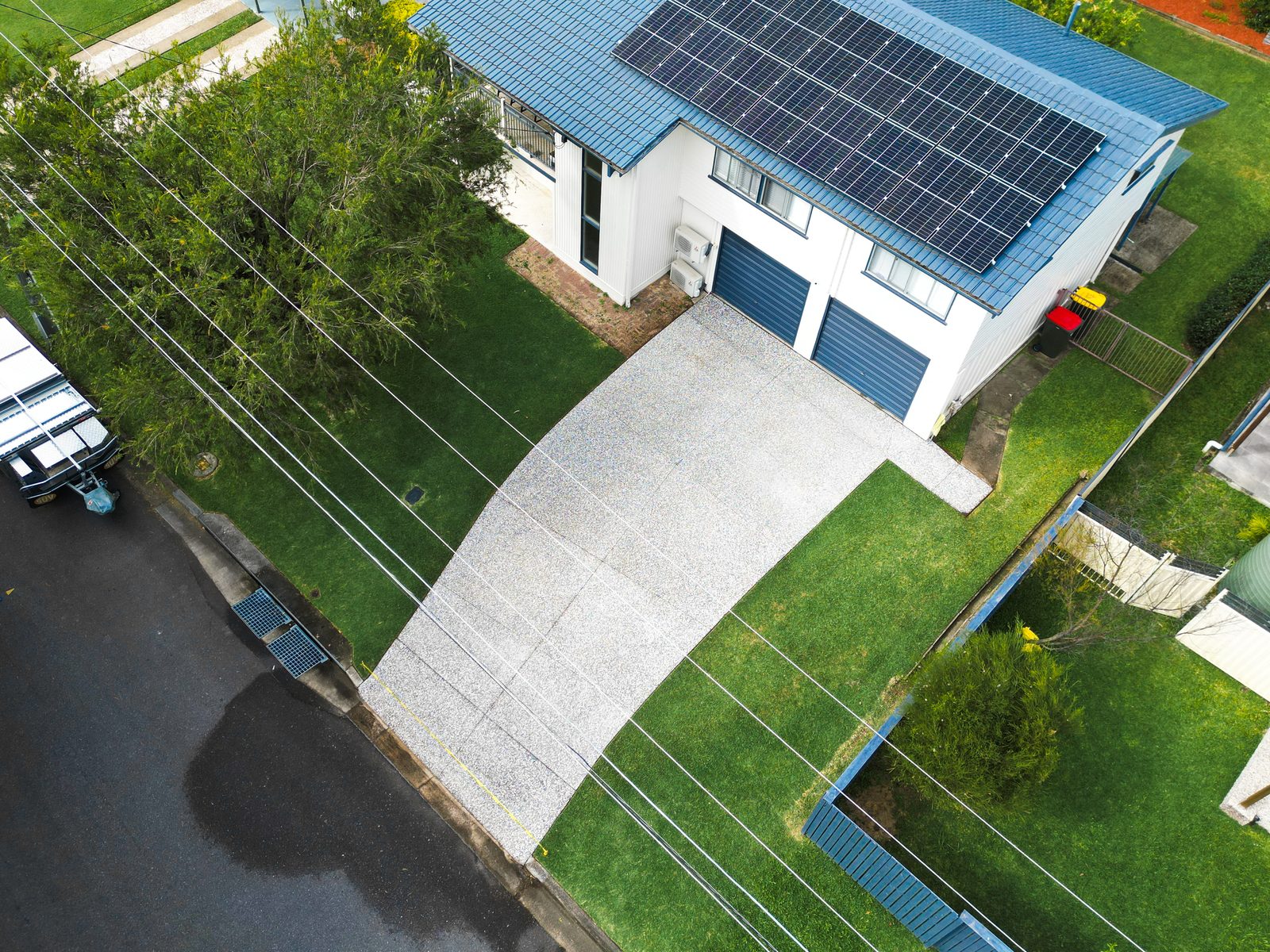 Exposed-aggregate driveway after clear penetrative sealing at a Mitchelton home in Brisbane, seen from above