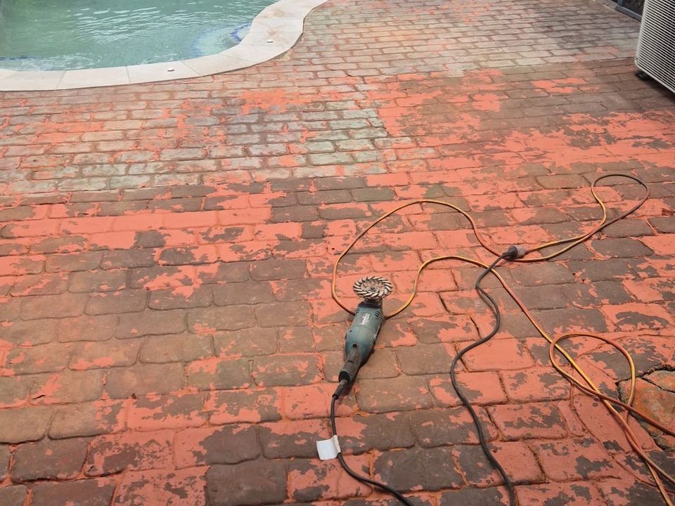 Before: Worn red pavers around a pool during preparation