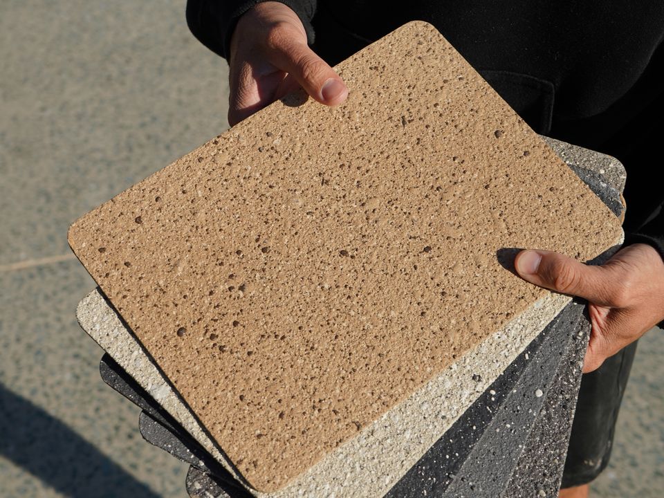 Sample boards held up at an on-site assessment