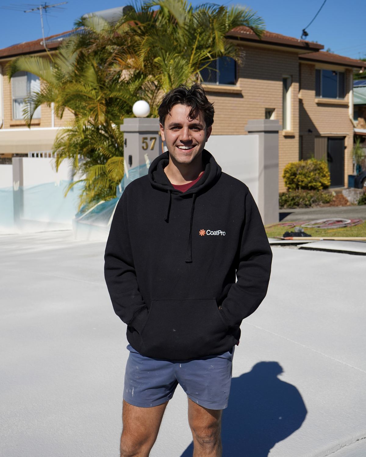 Lachlan, Director at CoatPro, on a freshly resurfaced driveway