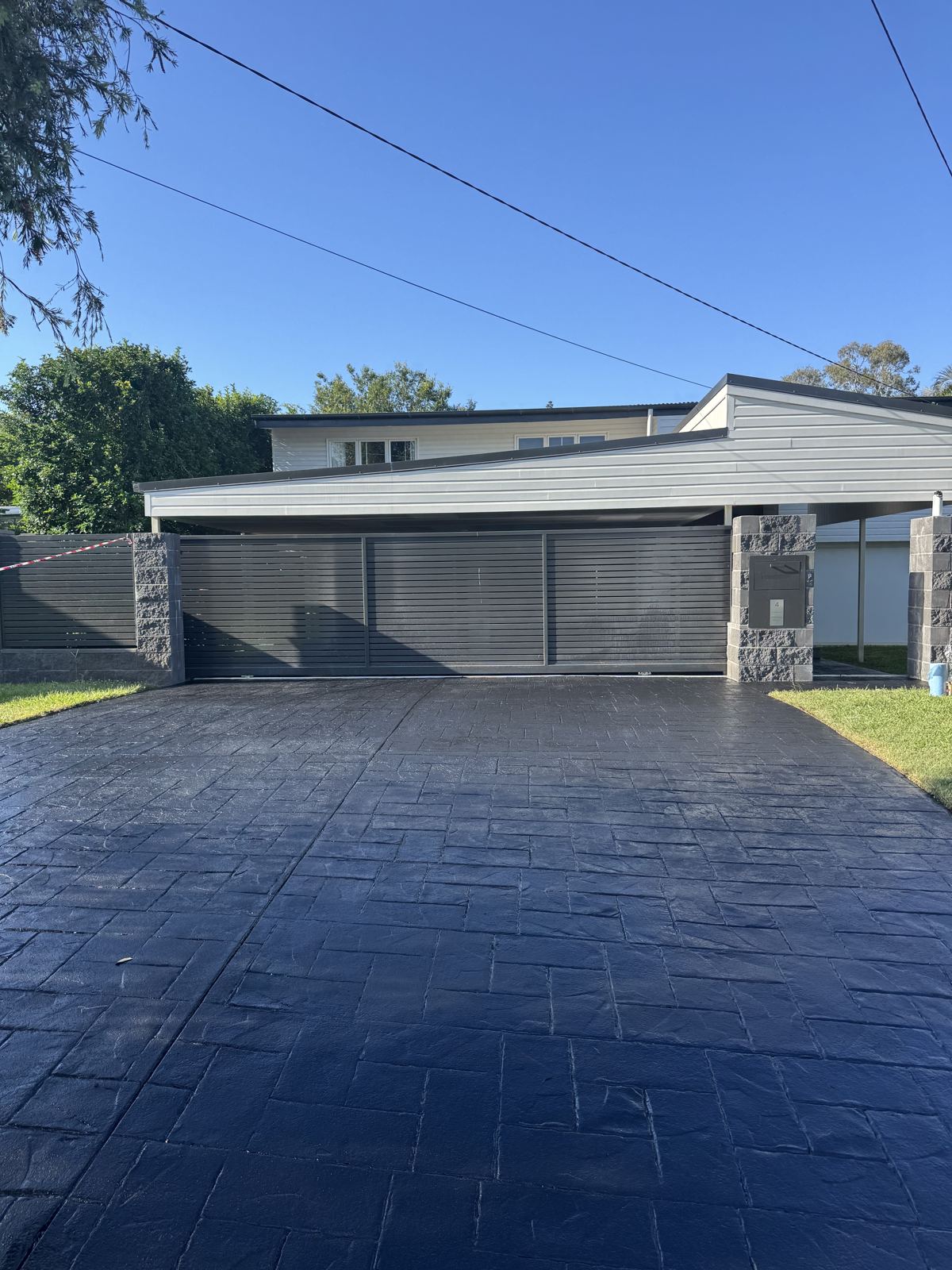 After: the same driveway resealed in black